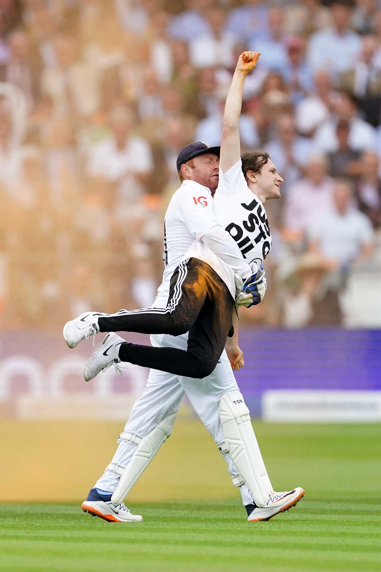 England's Johnny Bairstow carrying a Just Stop Oil protestor off the pitch during day one of the second Ashes test match at Lord's, London. Picture date: Wednesday June 28, 2023. PA Photo. See PA Story CRICKET England. Photo credit should read: Mike Egerton/PA Wire. RESTRICTIONS: Editorial use only. No commercial use without prior written consent of the ECB. Still image use only. No moving images to emulate broadcast. No removing or obscuring of sponsor logos.