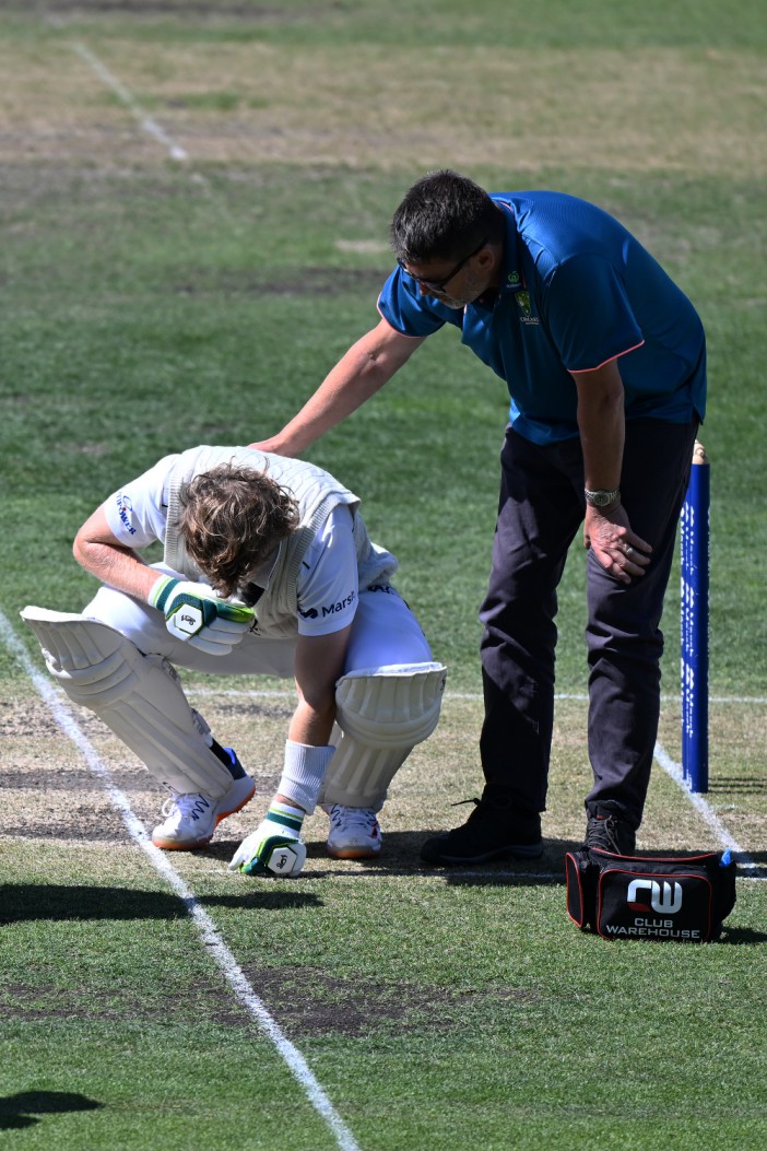 HOBART, AUSTRALIA - MARCH 03: Will Pucovski of the Bushrangers is checked by medical staff after being struck by a delivery from Riley Meredith of the Tigers during the Sheffield Shield match between Tasmania and Victoria at Blundstone Arena, on March 03, 2024, in Hobart, Australia. (Photo by Steve Bell/Getty Images)