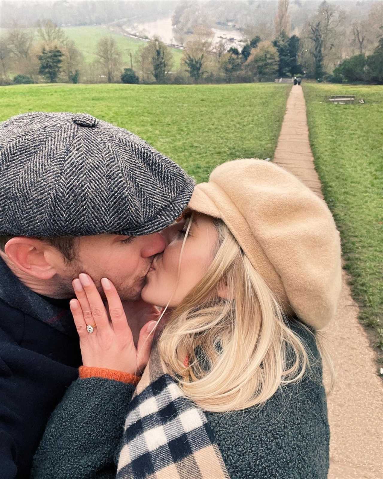 a man in a hat kisses a woman on the cheek