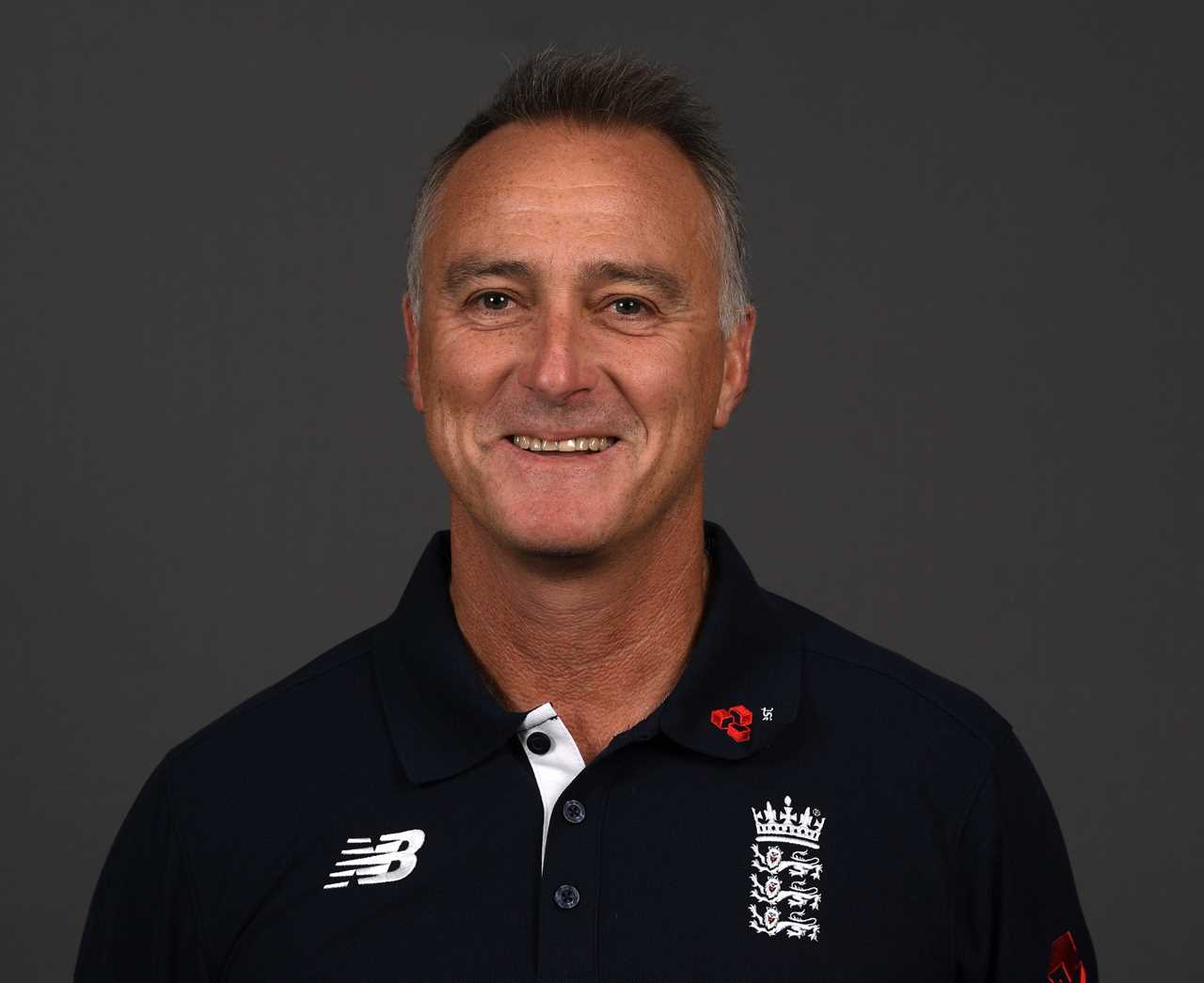 a man wearing a new balance shirt smiles for the camera