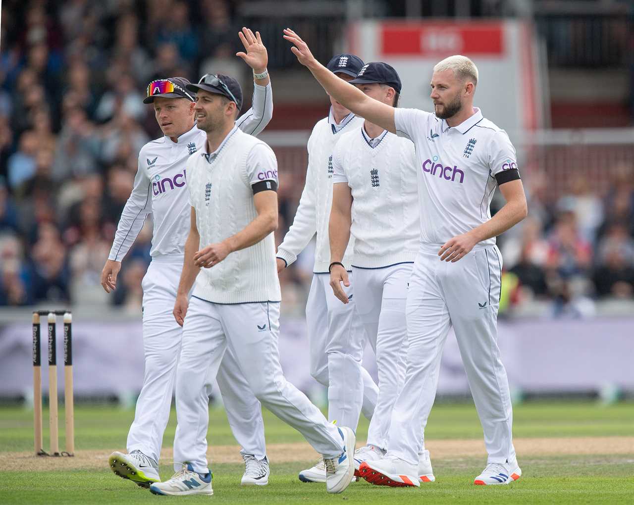 a group of cricket players with cinch on their shirts