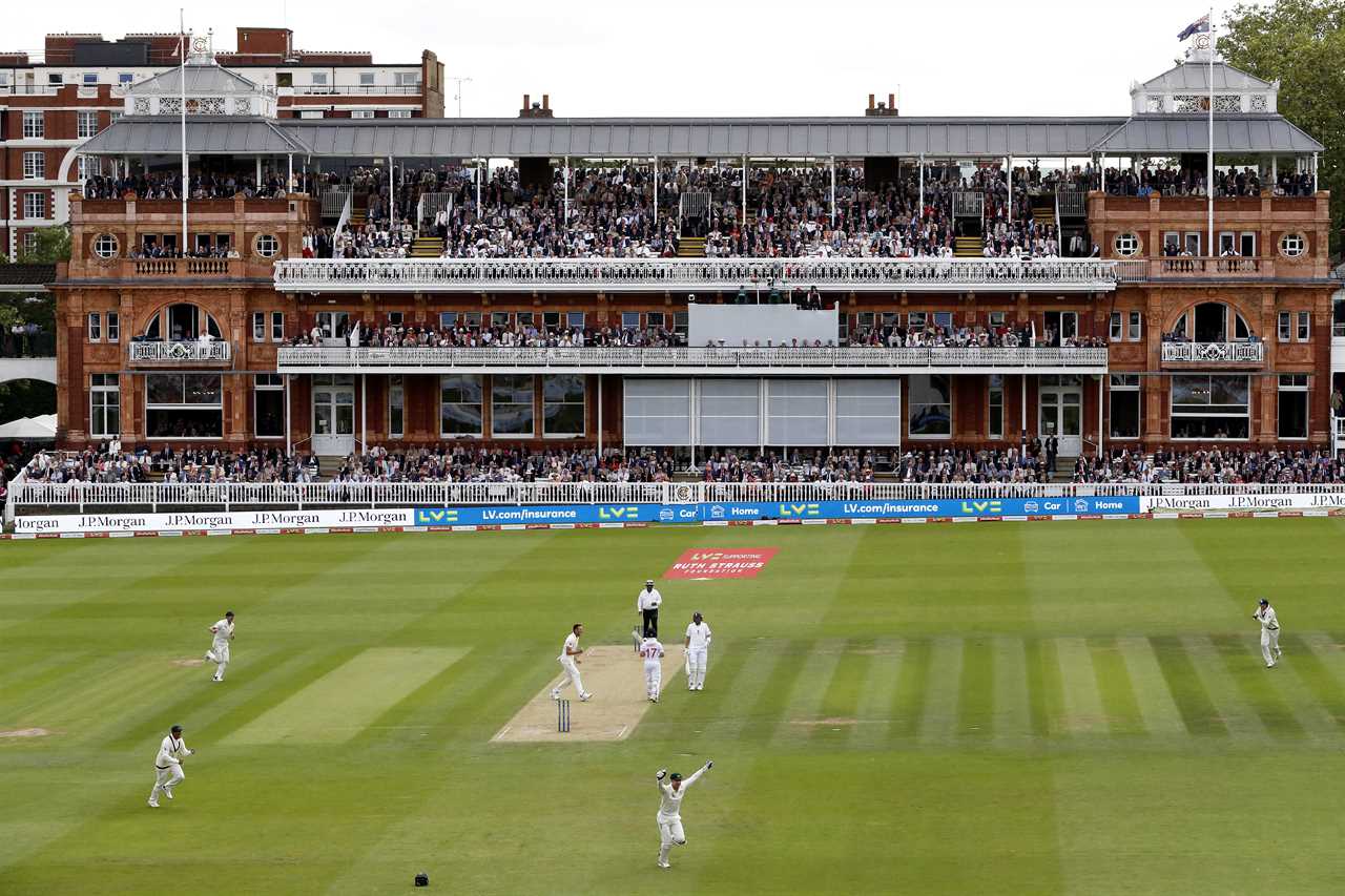 a cricket match is being played in front of a large stadium sponsored by lg morgan