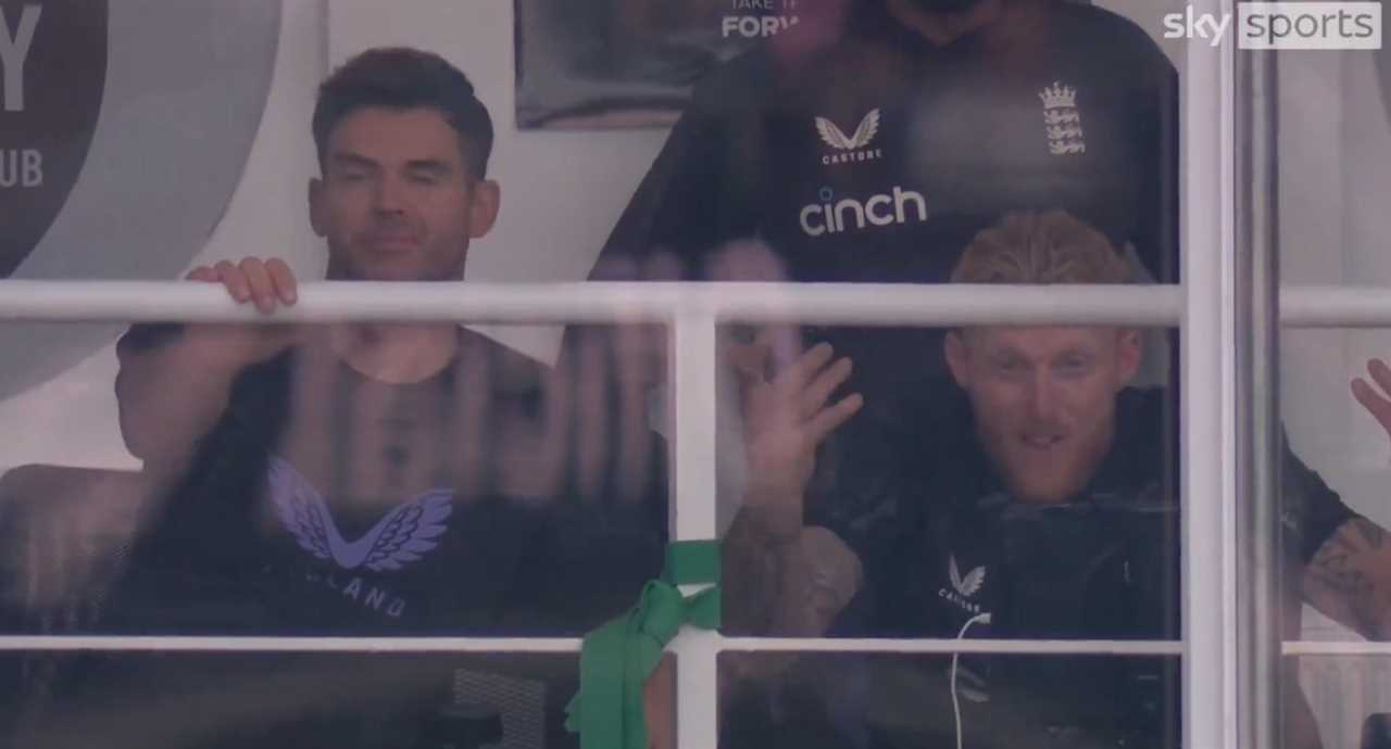 a man wearing a cinch shirt looks out a window