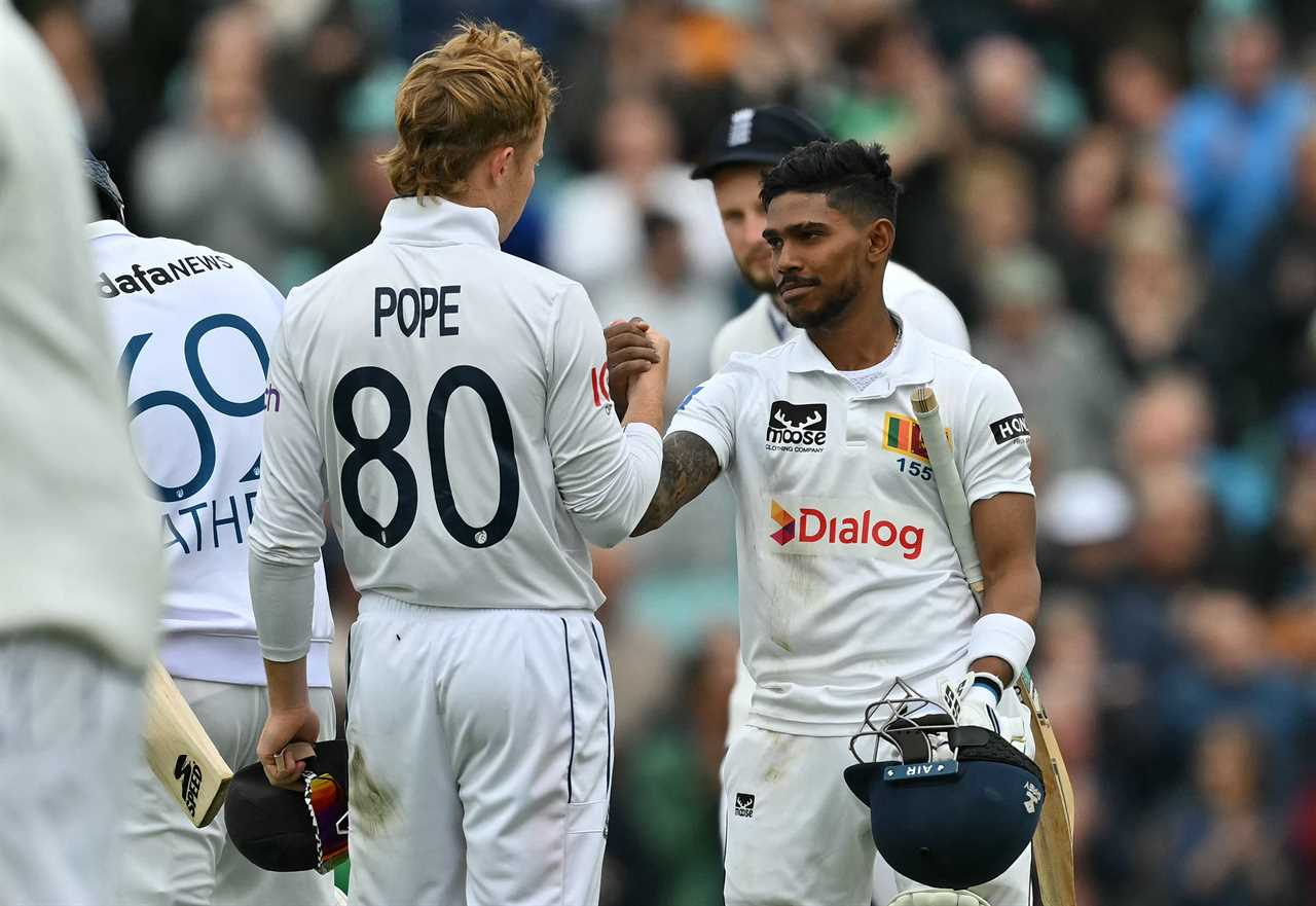 a player with the number 80 on their jersey shakes hands with another player