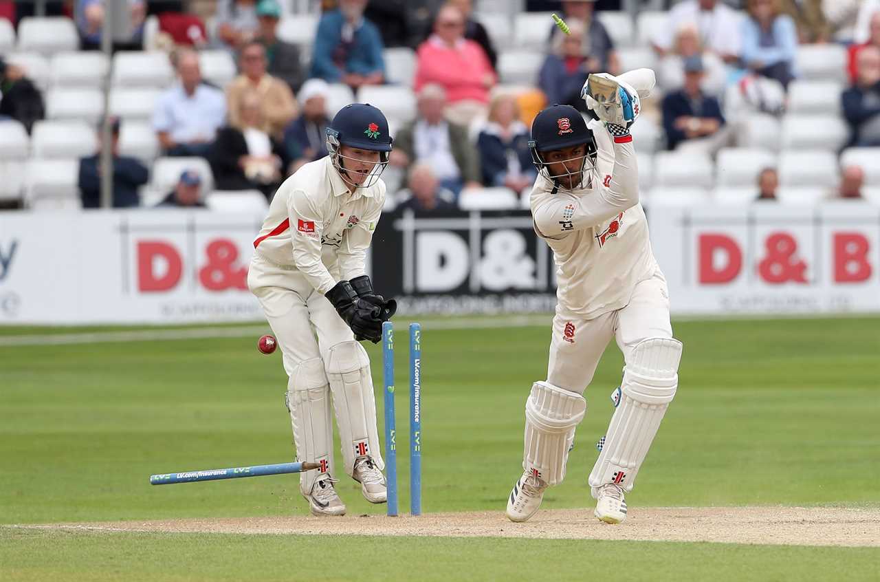 a cricket game is being played in front of a sign that says d & b