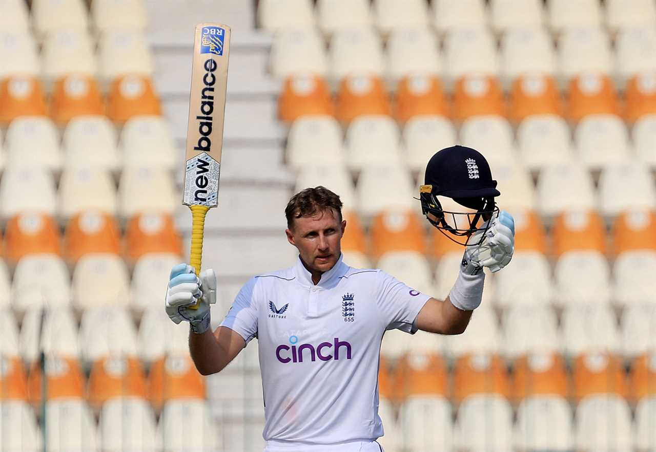 a cricket player wearing a cinch shirt holds up his bat