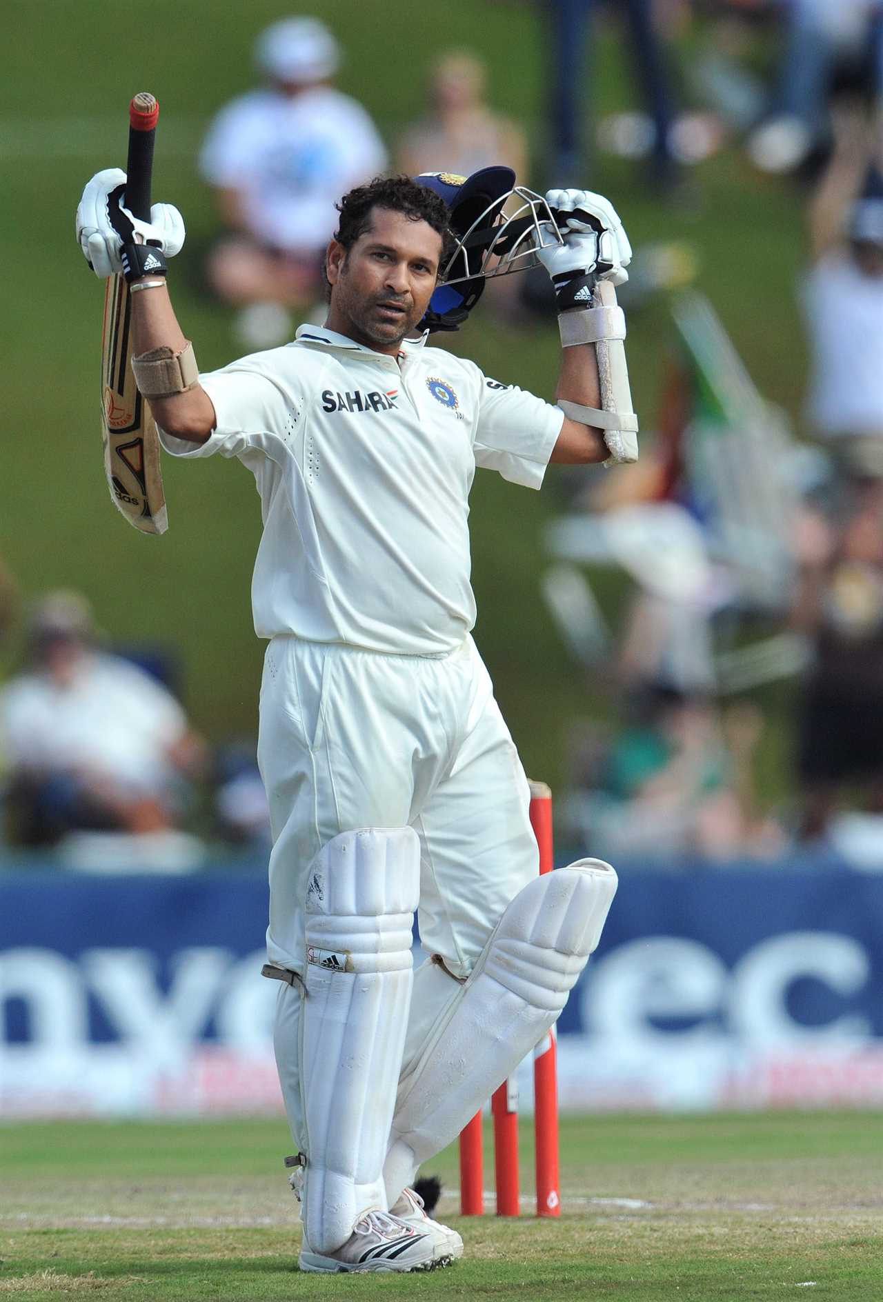 a cricket player wearing a white shirt that says s.h.r.f.