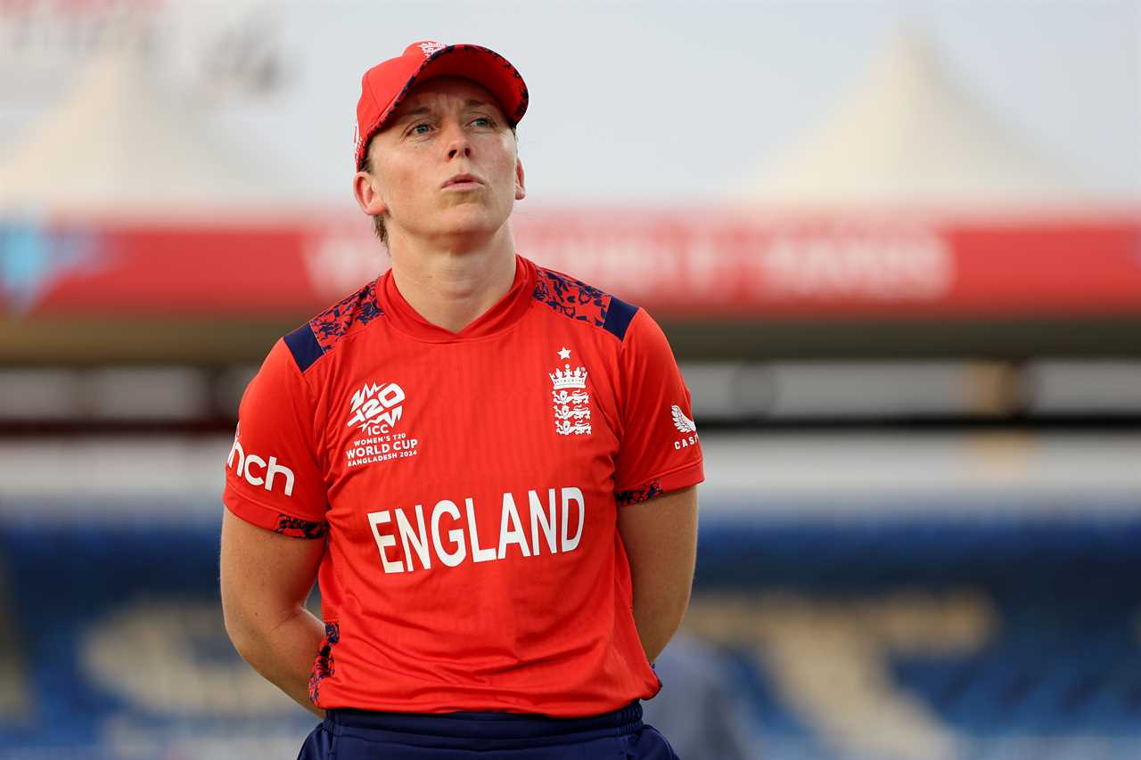 a woman wearing a red shirt that says england on it