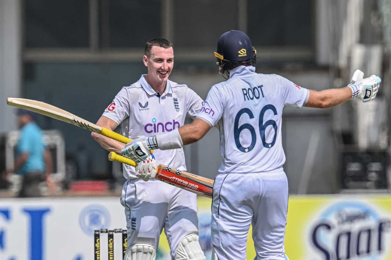 two cricket players brook and 88 are hugging each other