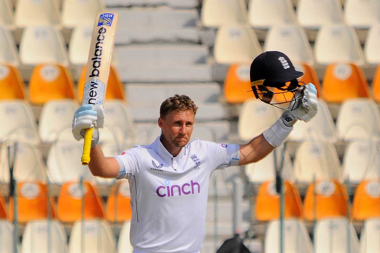 a man in a cinch shirt holds up his bat