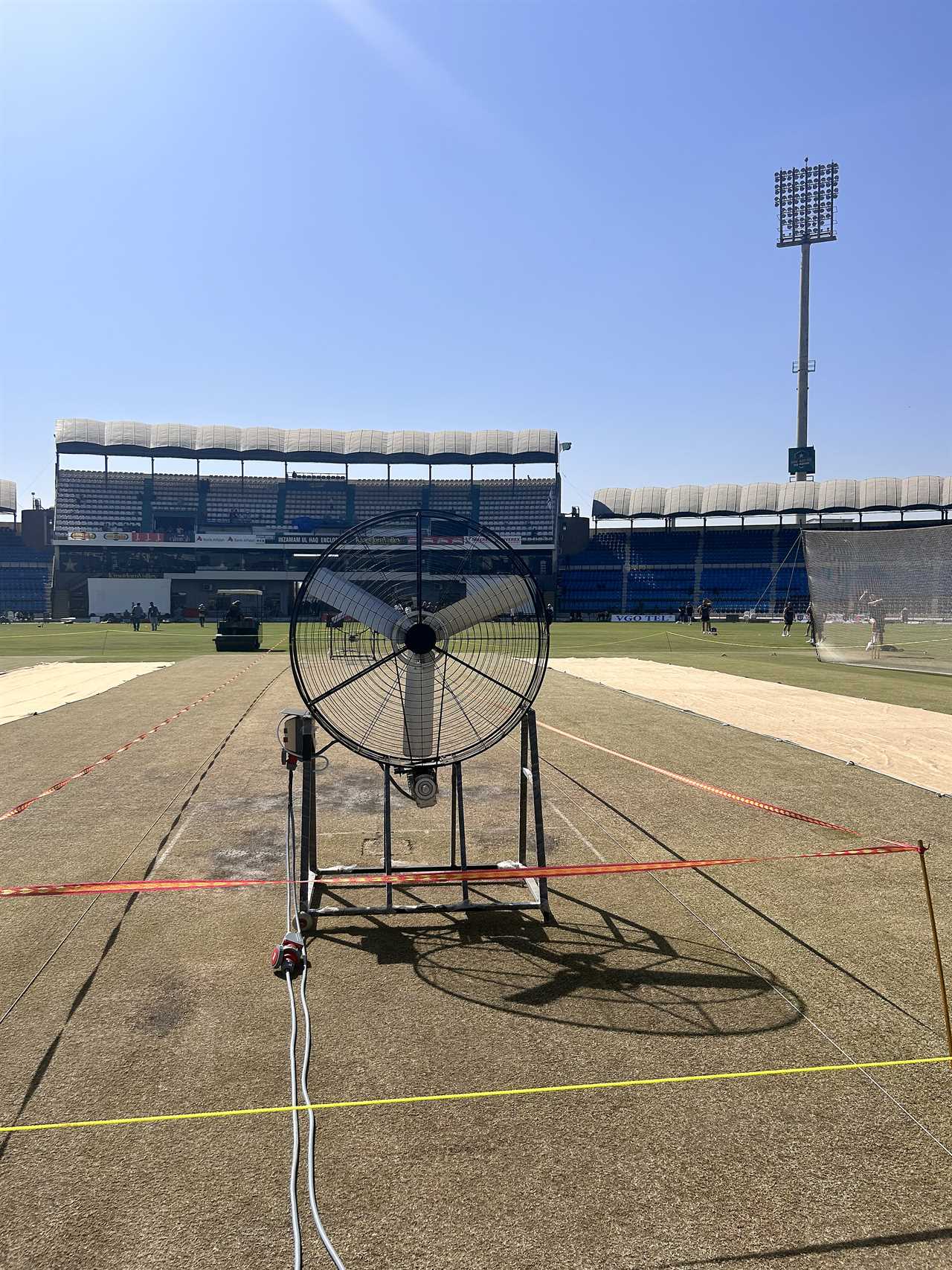 an empty stadium with a fan in front of it