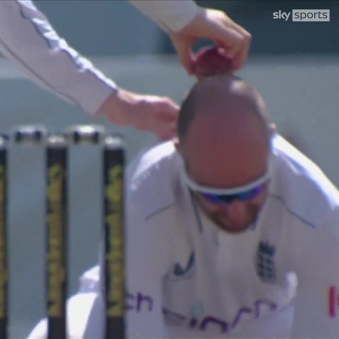 a man 's head is being shaved by a person with sky sports written on the bottom