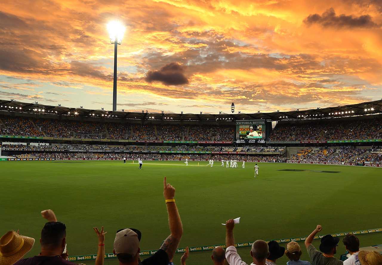 a crowd of people watching a cricket match at a stadium sponsored by bet365