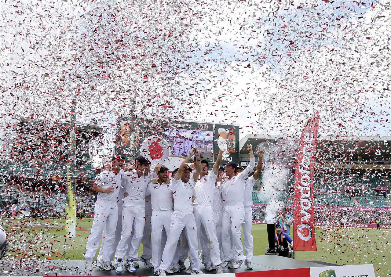 a group of cricket players stand on a podium with confetti falling around them