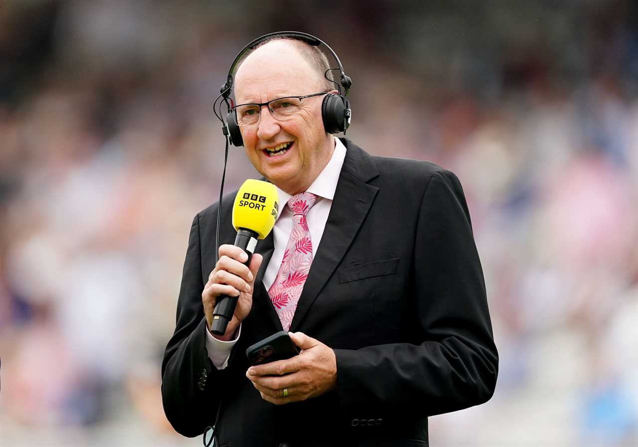 a man wearing headphones and a microphone that says bbc sport