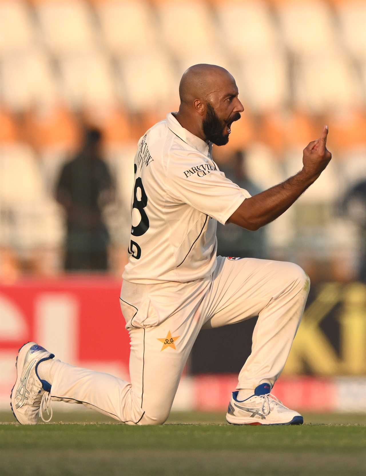 a man wearing a white shirt with the number 8 on it