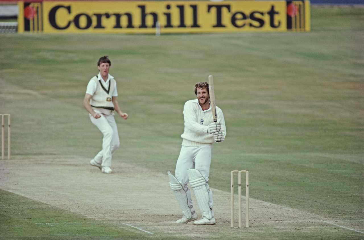 two cricket players on a field with a cornhill test sign in the background