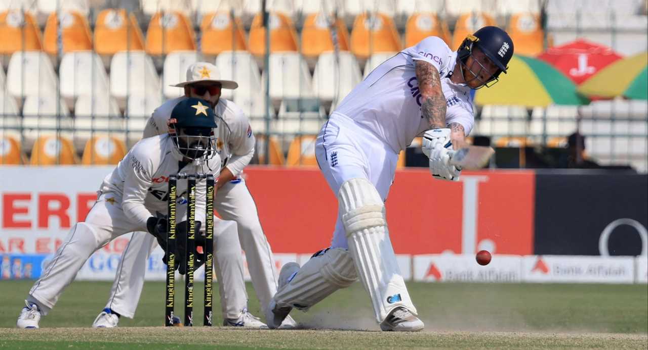 a cricket player wears a helmet that says ' england ' on it