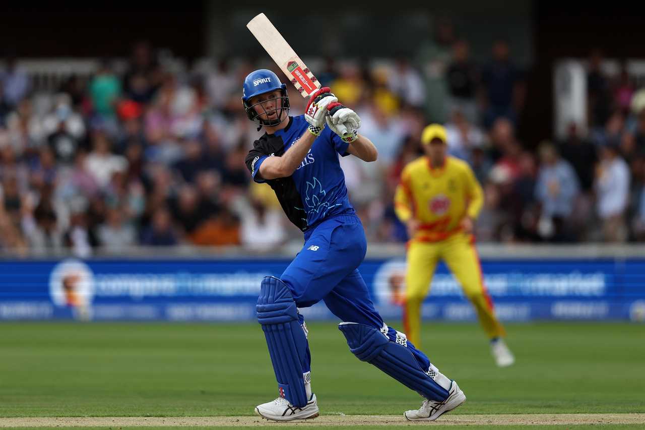 a cricket player wearing a helmet that says specsavers on it