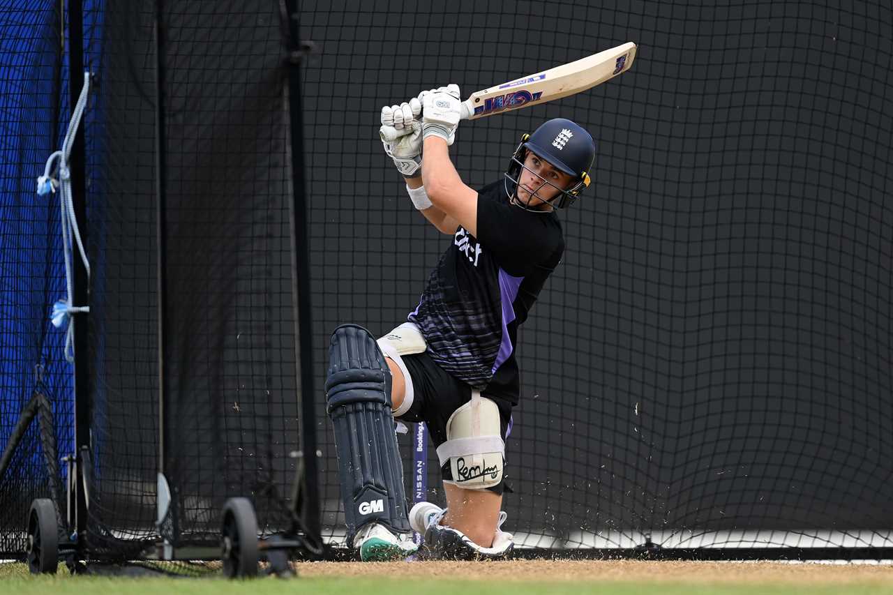 a cricket player wearing a helmet that says ' england ' on it