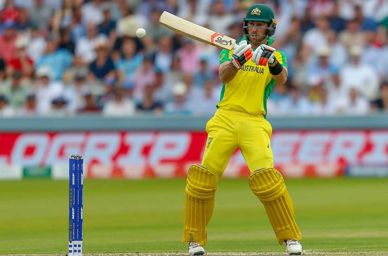 a cricket player from australia is swinging his bat at the ball