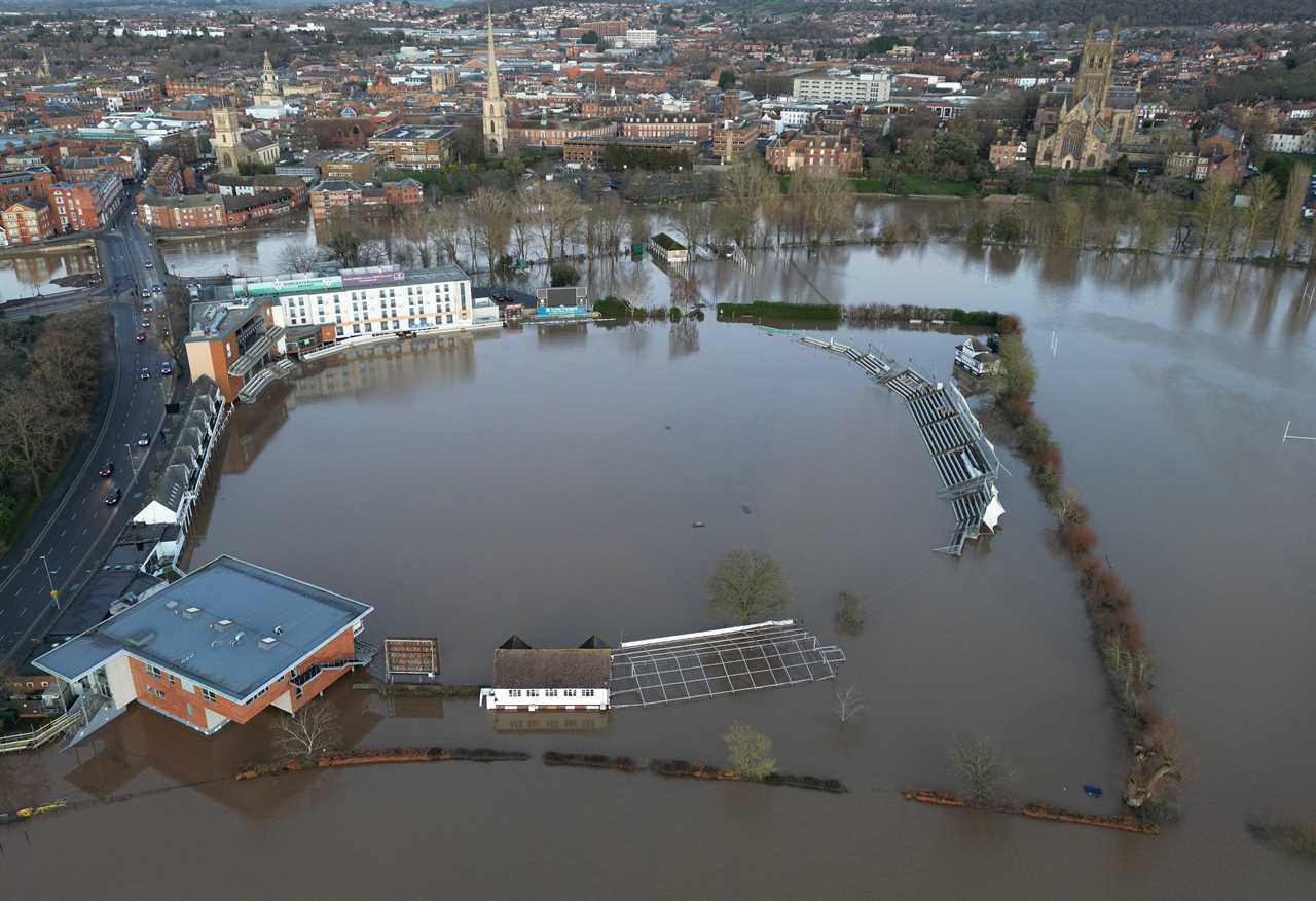 Aerial view of a cricket ground submerged in floodwater.