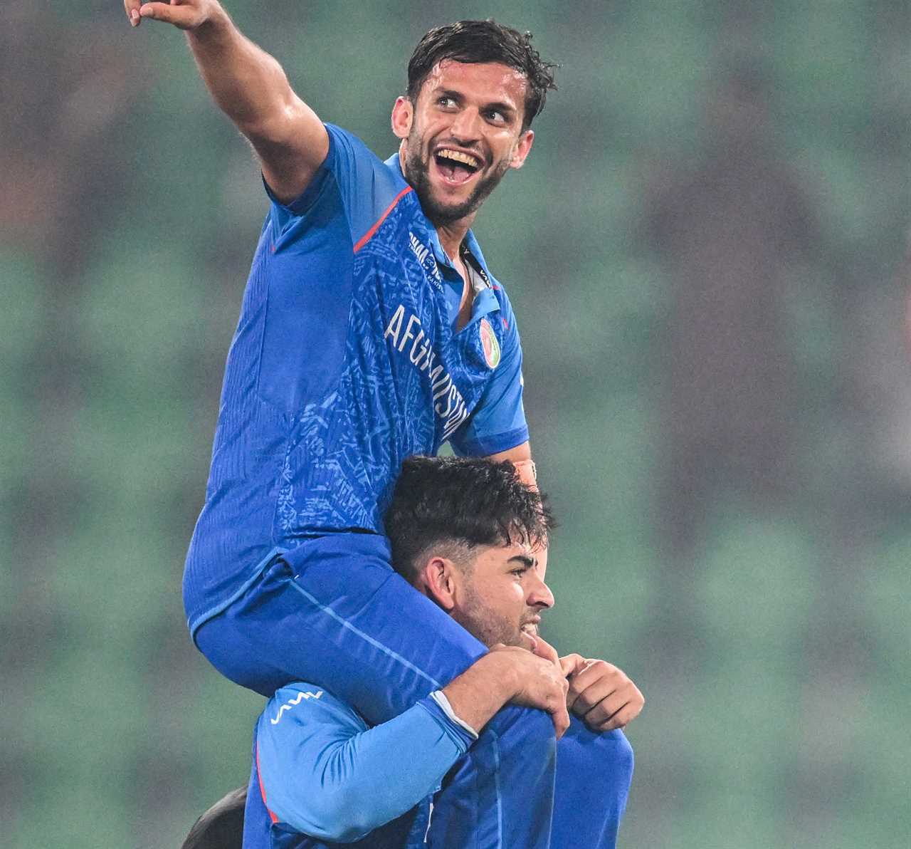 Afghan cricket players celebrating a victory.