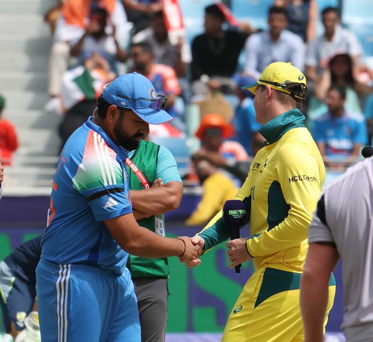 Indian and Australian cricket players shaking hands.