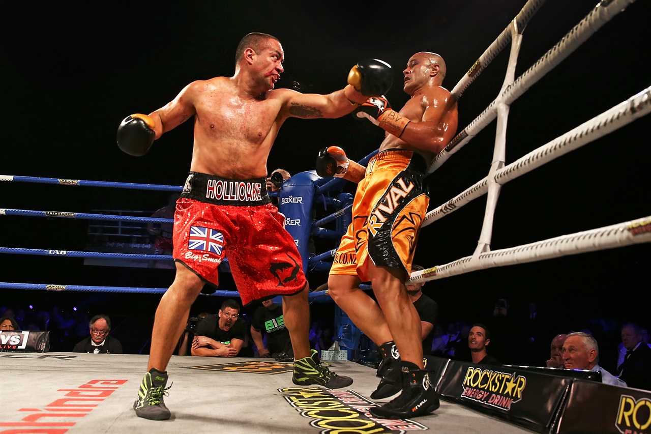 Two boxers fighting in a boxing ring.