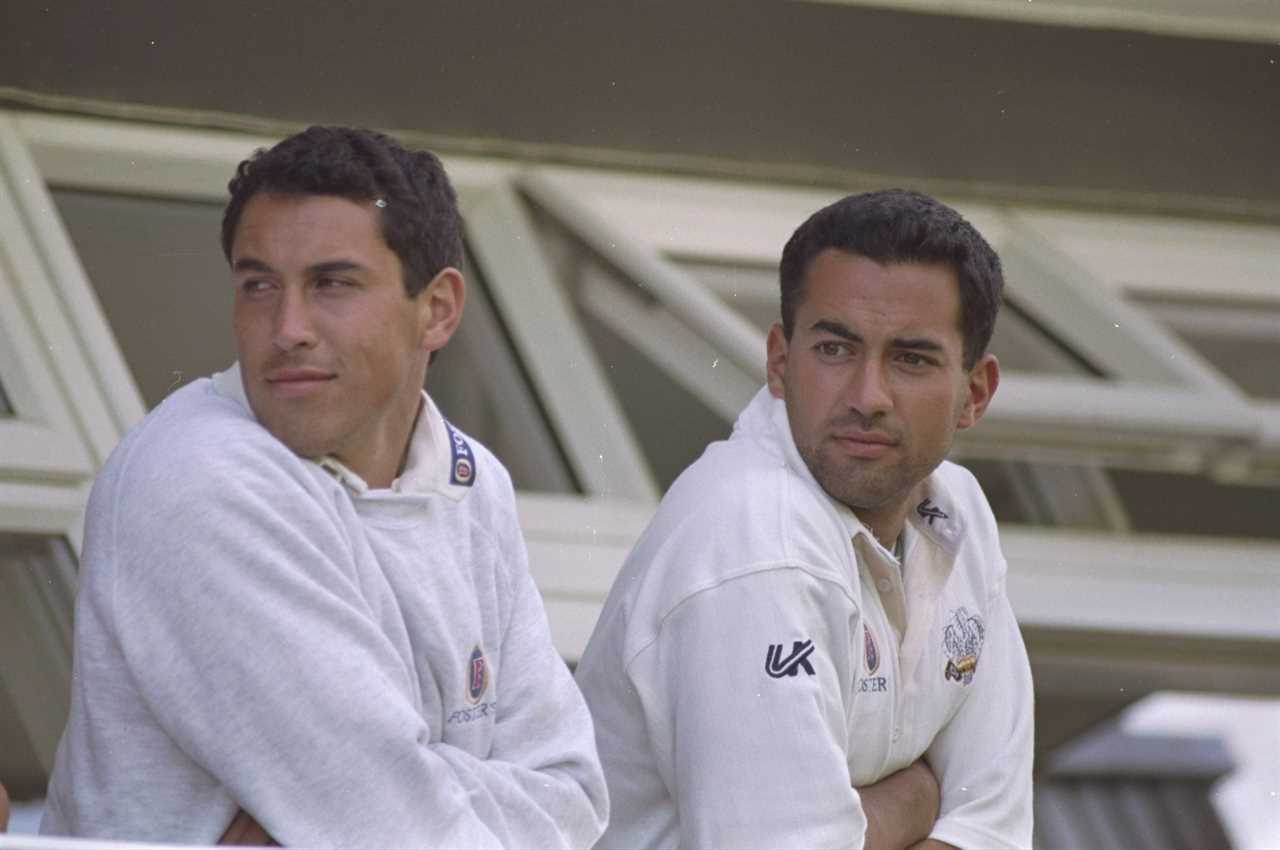 Ben and Adam Hollioake of Surrey watching a cricket match.