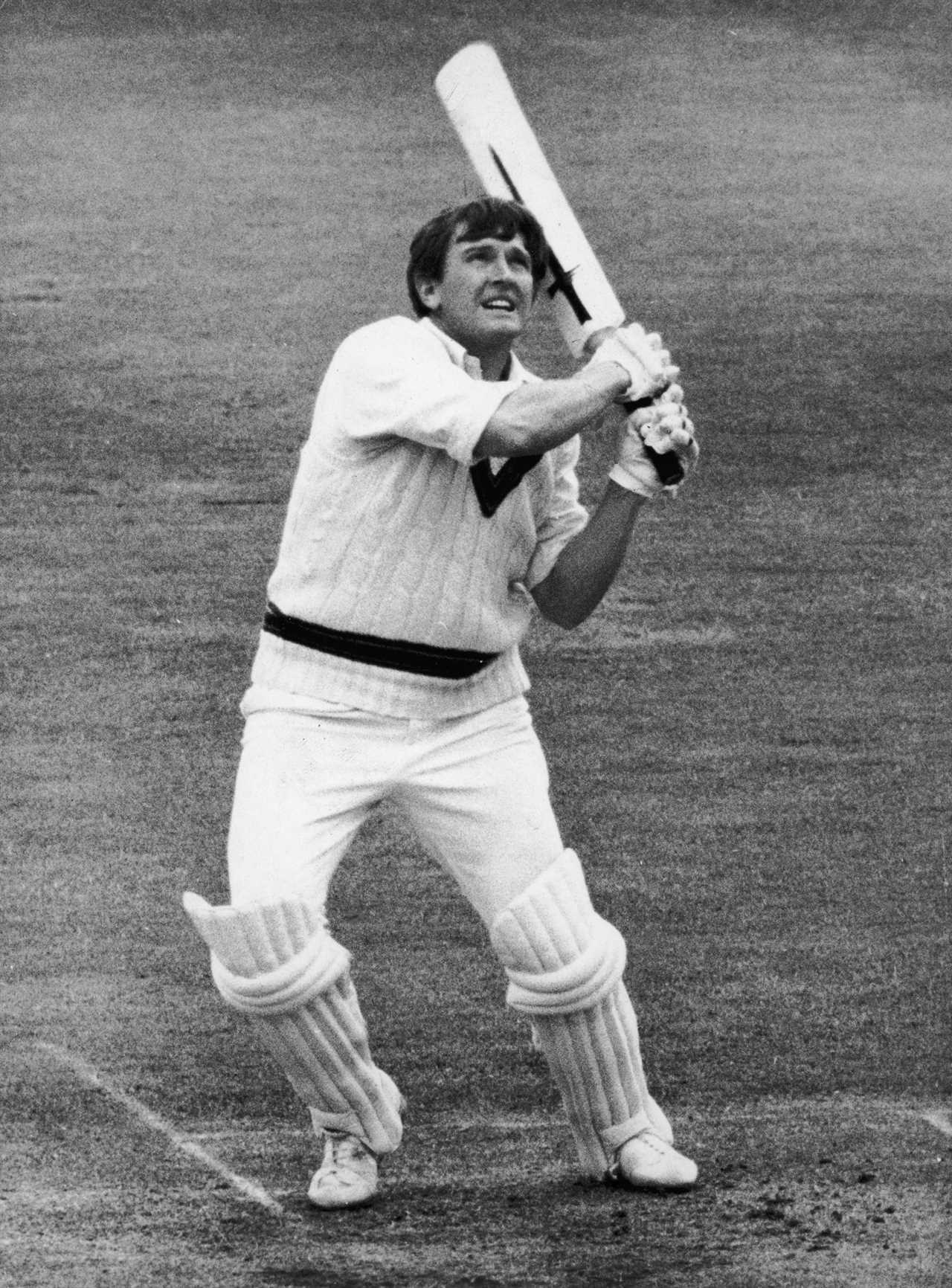 Black and white photo of Keith Stackpole hitting a cricket ball.