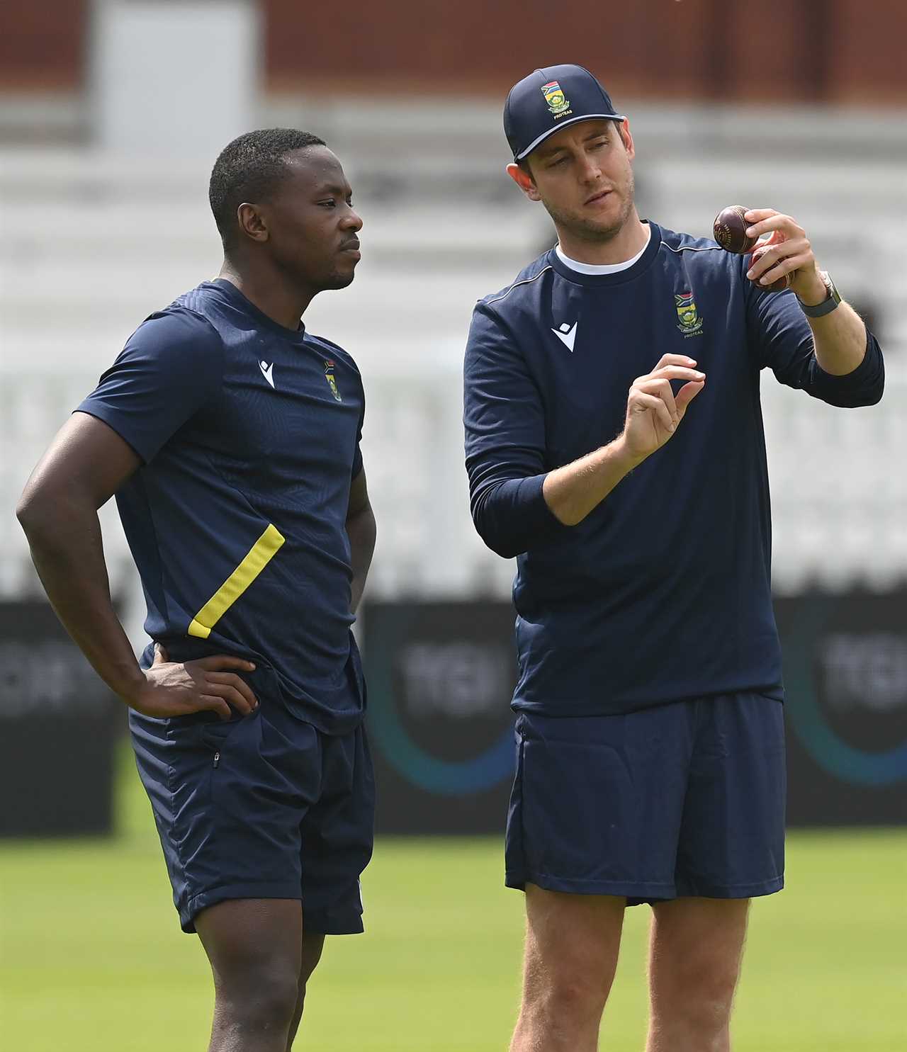 Stuart Broad, bowling consultant, speaks with Kagiso Rabada during a South Africa training session.