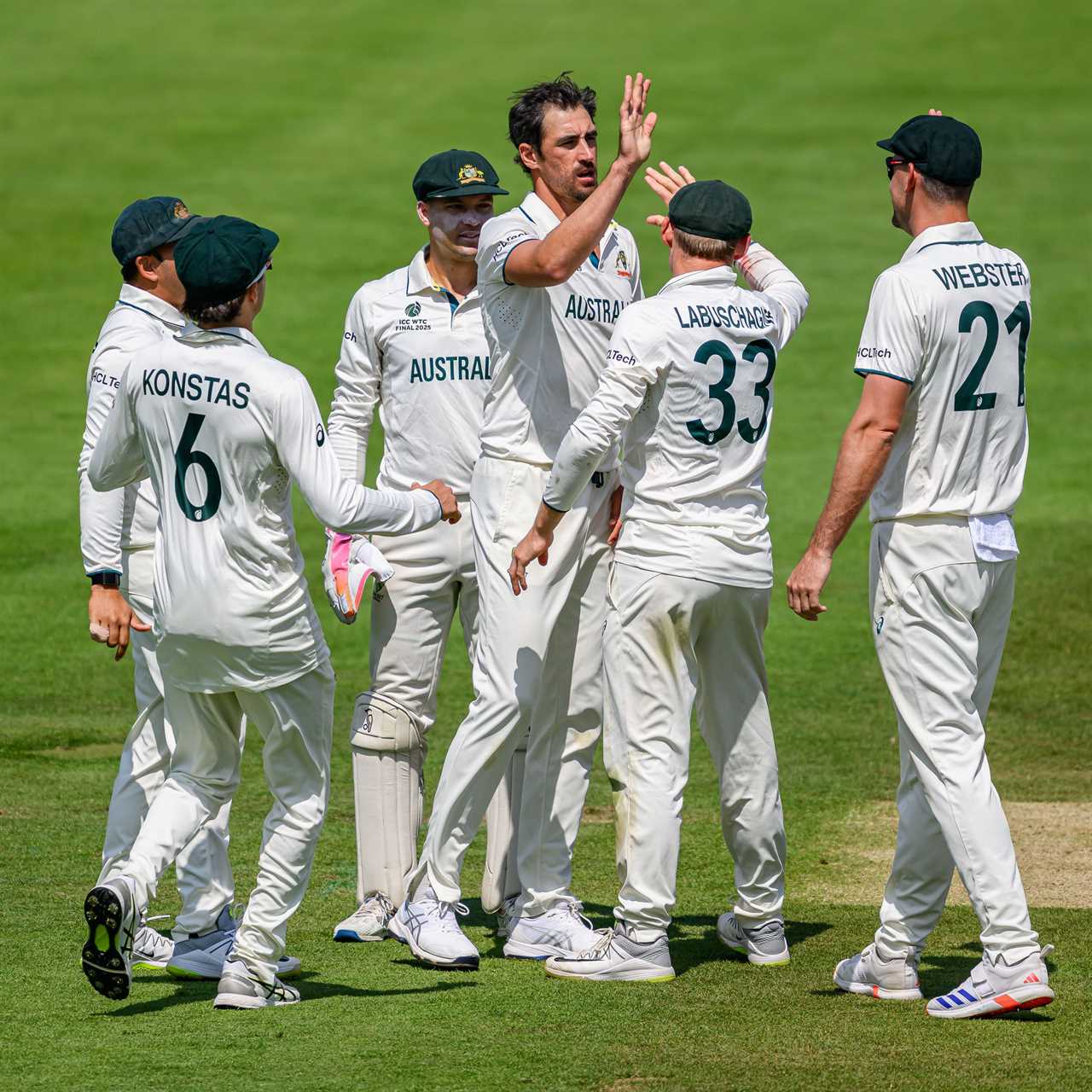 Australian cricket team celebrating a wicket.