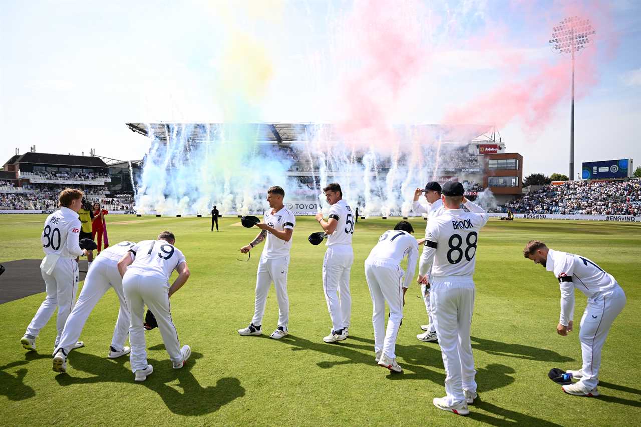 England cricket team on the field with fireworks exploding.