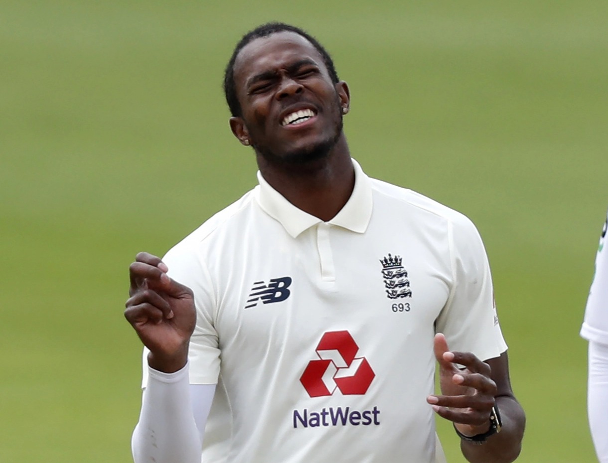 Jofra Archer, England cricketer, in a white cricket uniform.