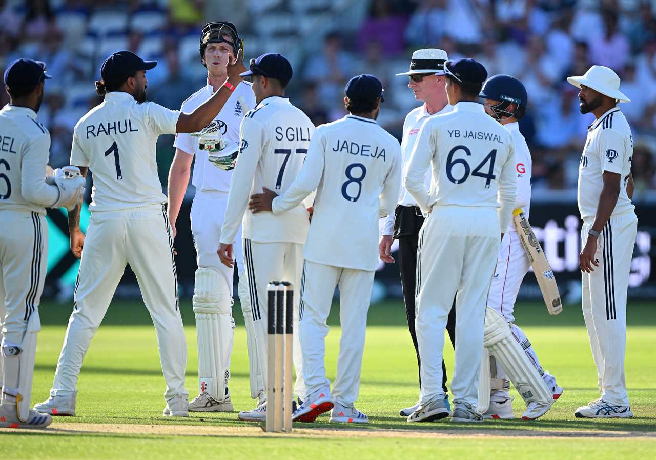 Cricket players interacting at the end of a game.