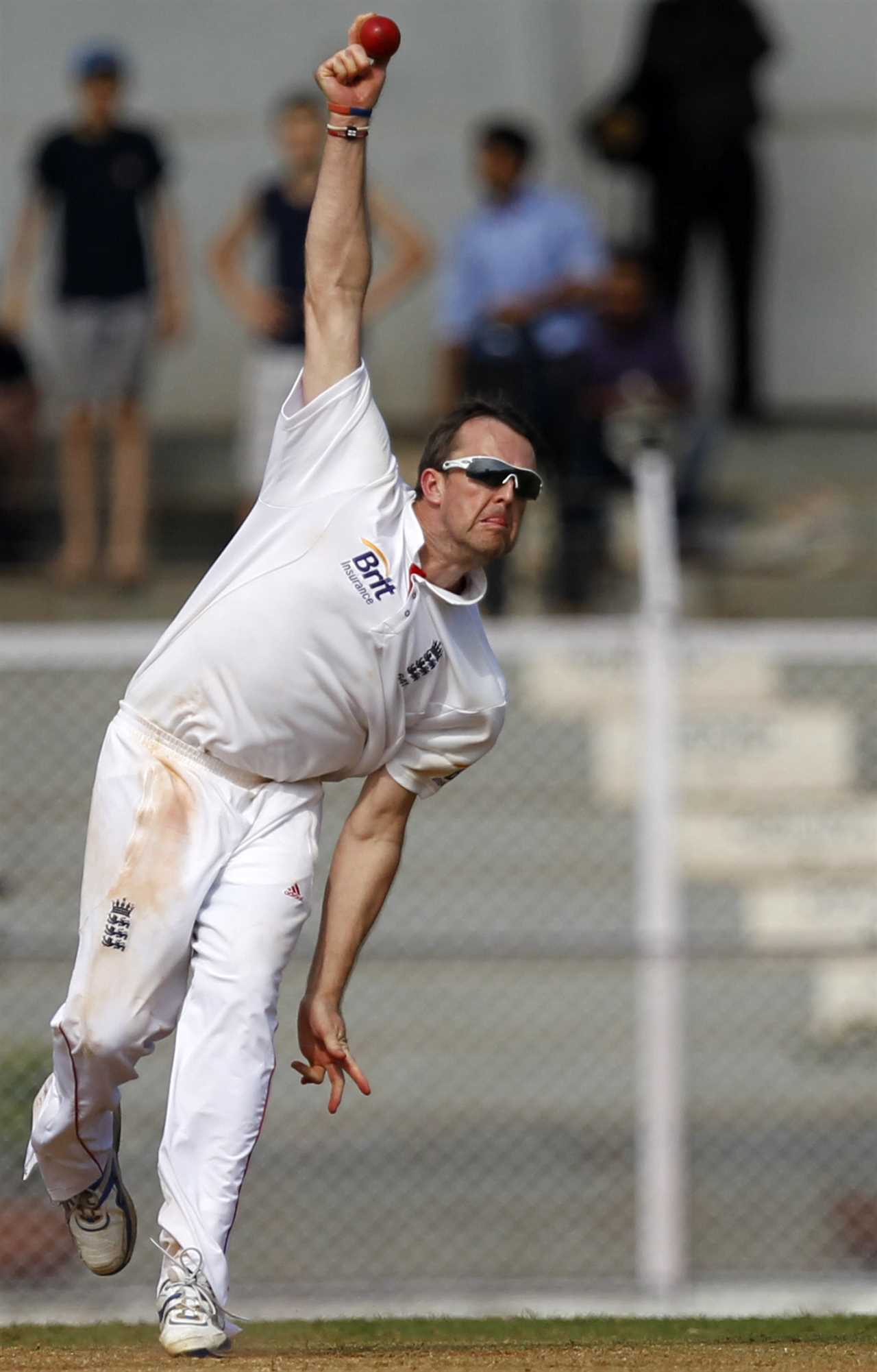 Graeme Swann, England cricketer, bowling a ball.