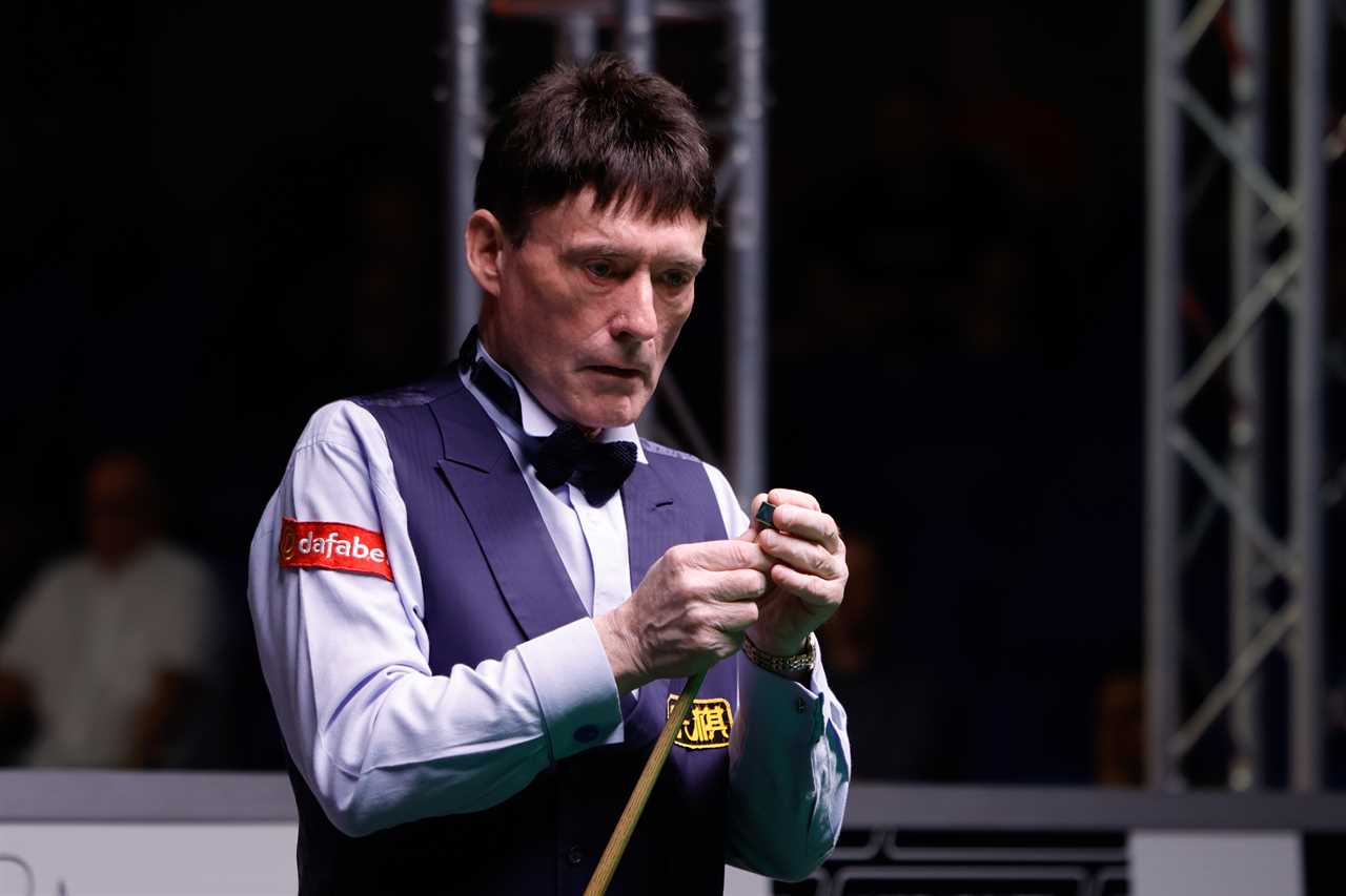 Jimmy White chalking his cue.