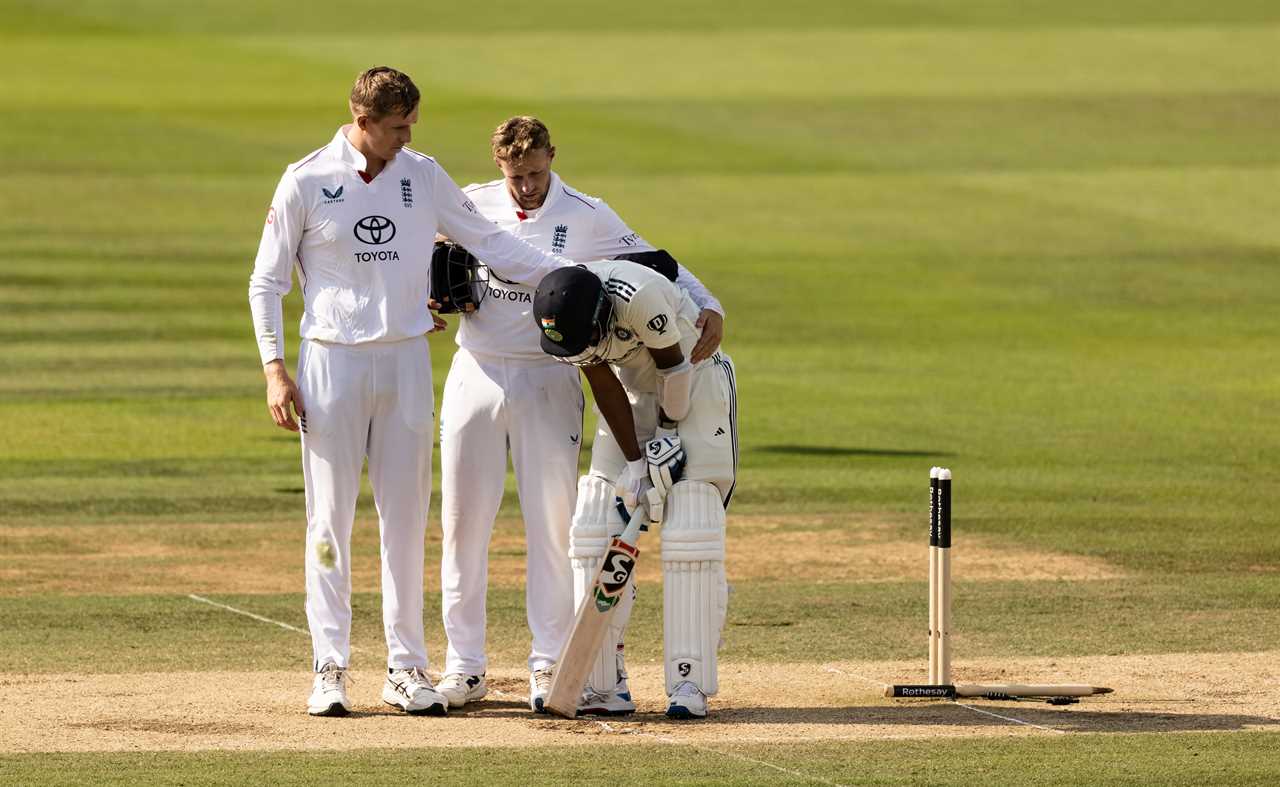 Cricket players consoling a distraught teammate.