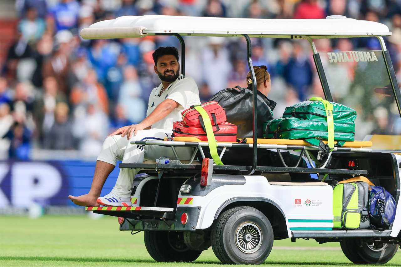 Rishabh Pant of India leaves the field on a medical cart after being hit by a ball.