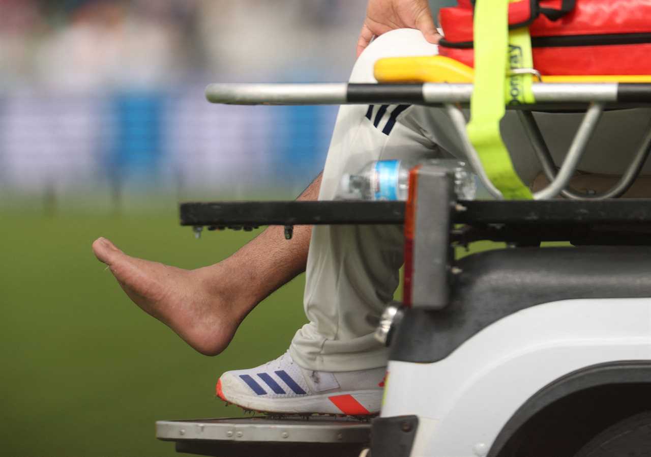 Injured cricketer being stretchered off the field.