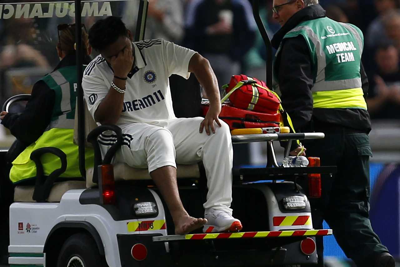 Rishabh Pant of India being helped from the field after an injury.