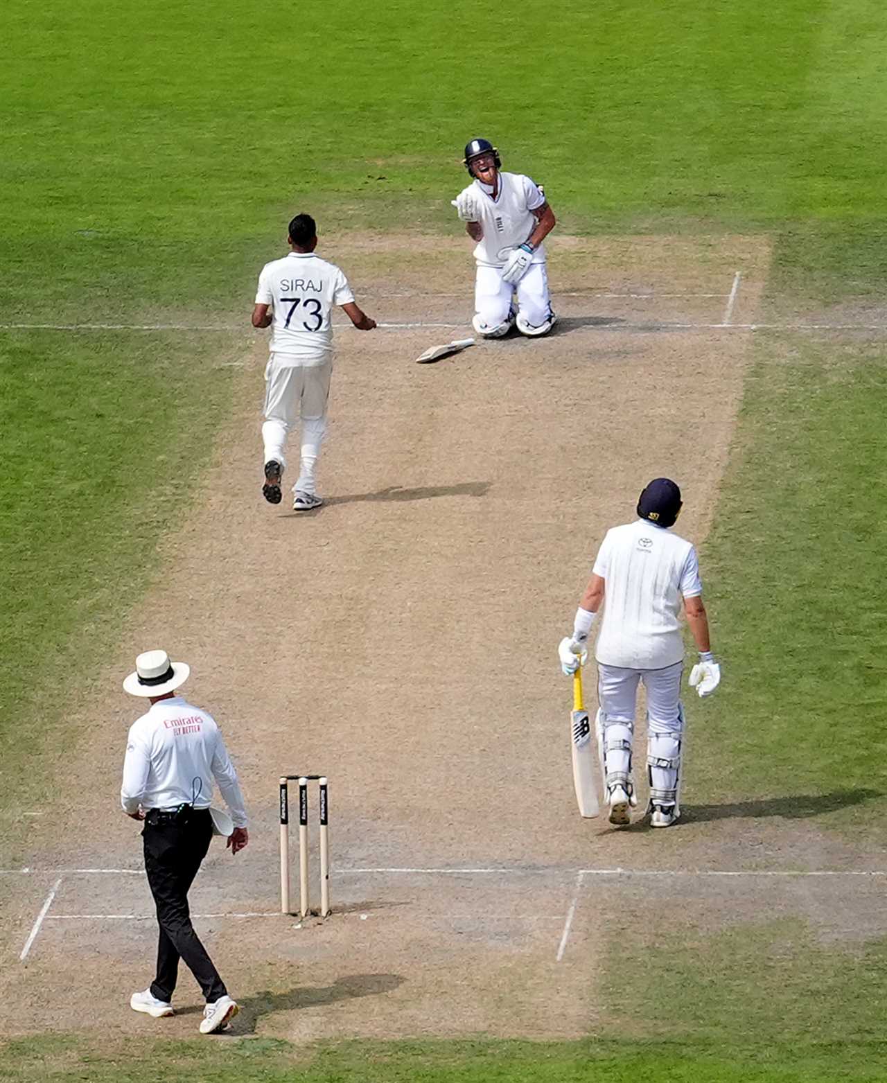 England's Ben Stokes reacts after being hit by a ball during a cricket match.