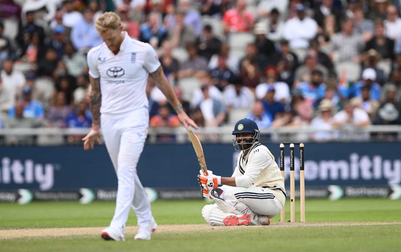 Ravindra Jadeja smiles after being bowled during a cricket match.