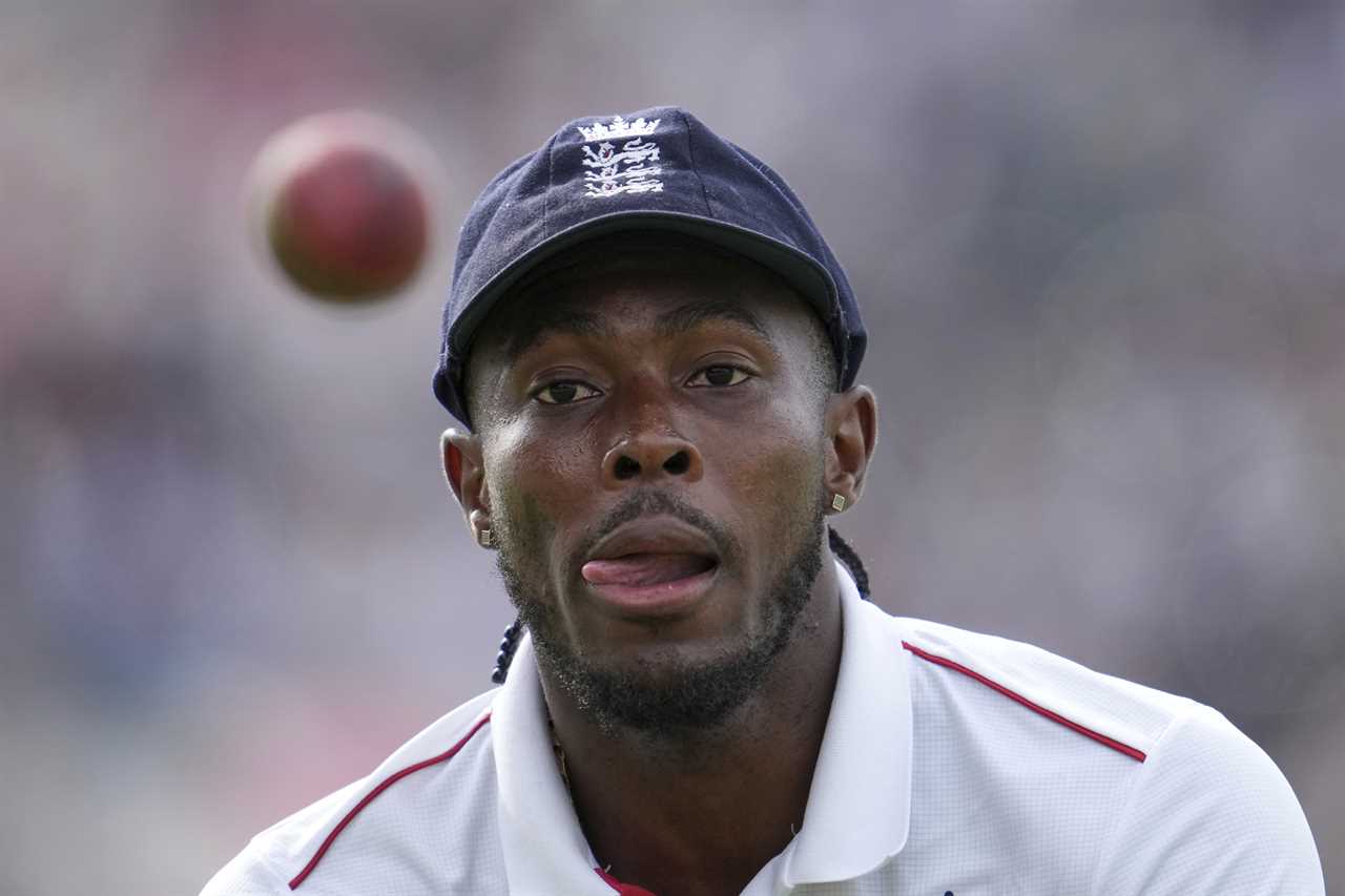 Jofra Archer fielding a cricket ball.
