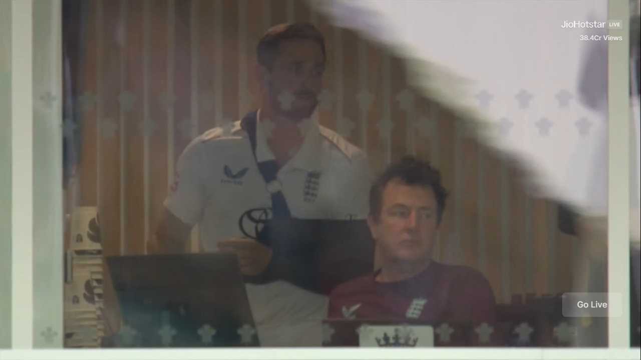 Two cricket players in a room.