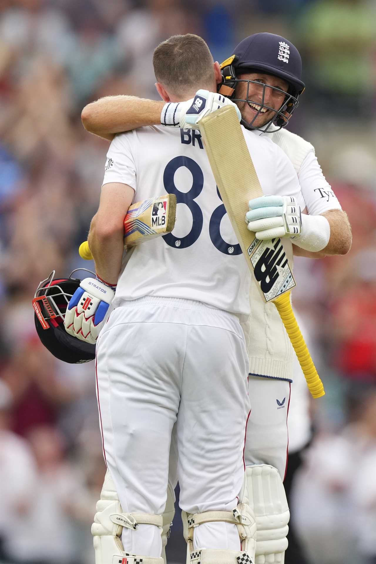 Harry Brook and Joe Root celebrating a cricket century.