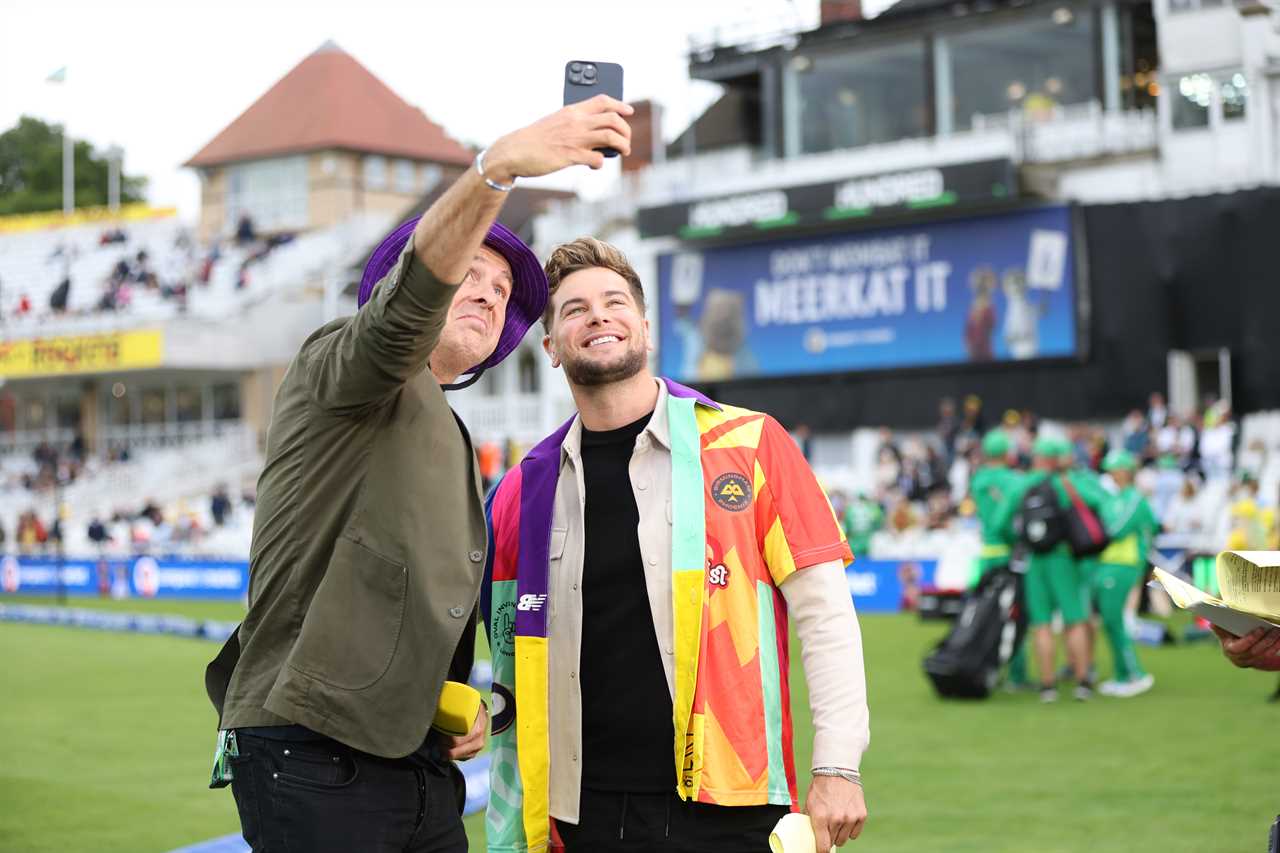 Michael Vaughan and Chris Hughes taking a selfie at a cricket match.