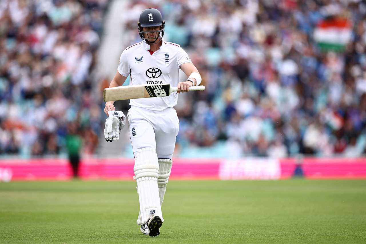 Jamie Smith walking off the cricket pitch after being dismissed.