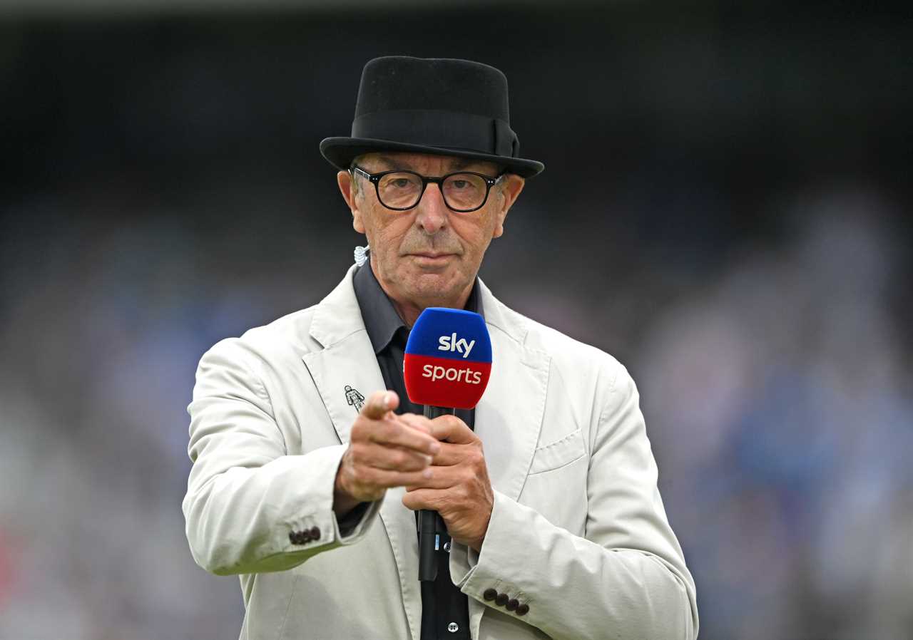David Lloyd, Sky Sports commentator, holding a microphone.